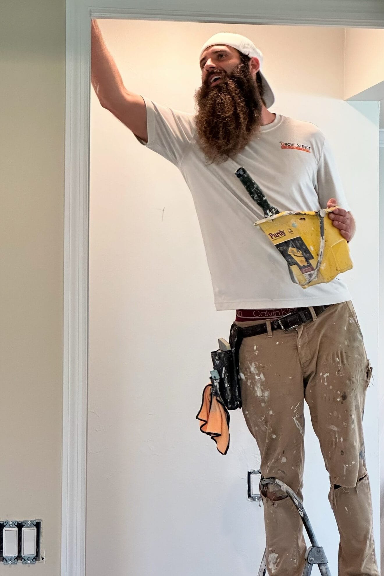 Brandon painting a door