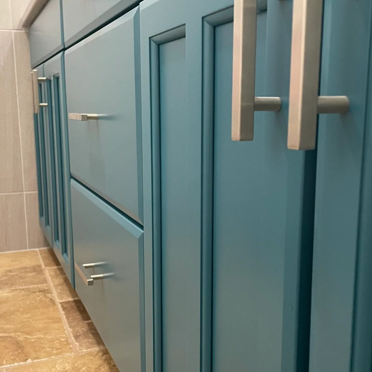 Close up angle on blue vanity with smooth paint finish