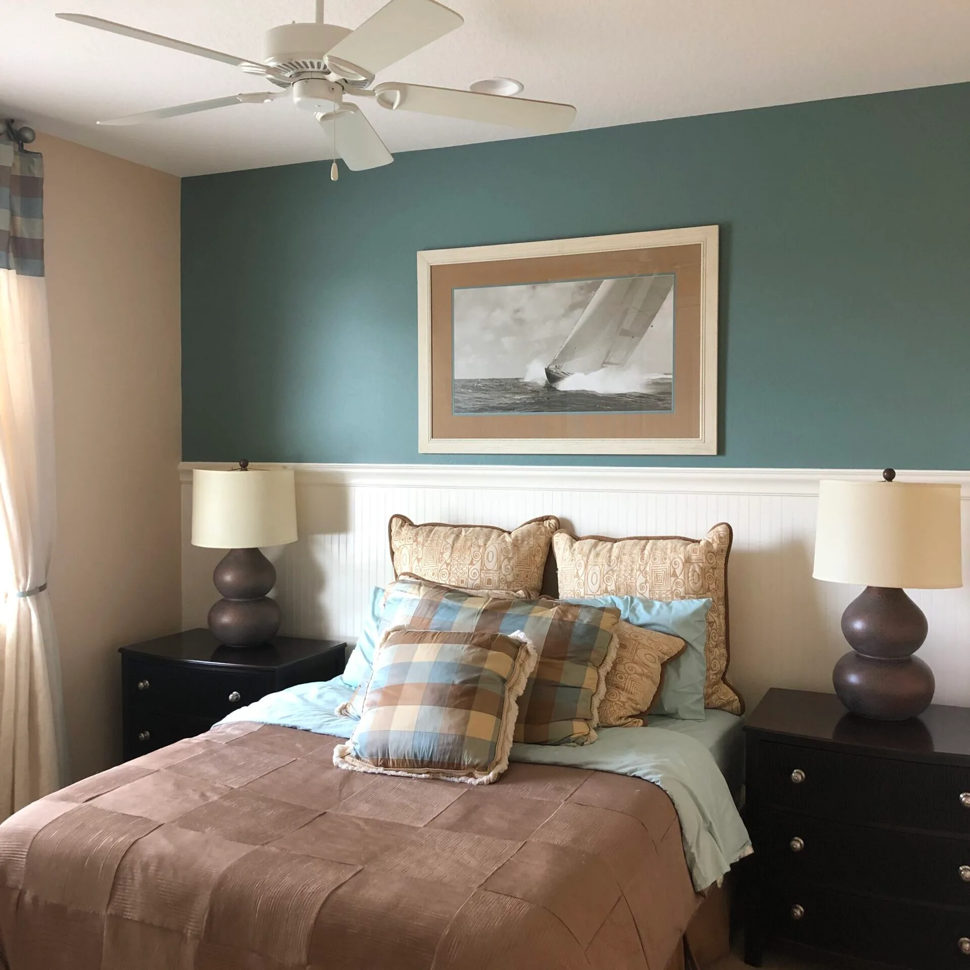 Bedroom with back wall painted with a blue accent