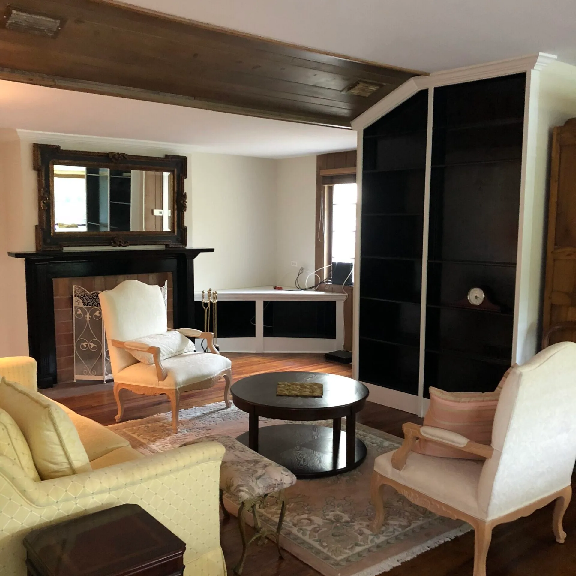 Historic Interior Restored With Wood Ceiling Accent And Black Built-In