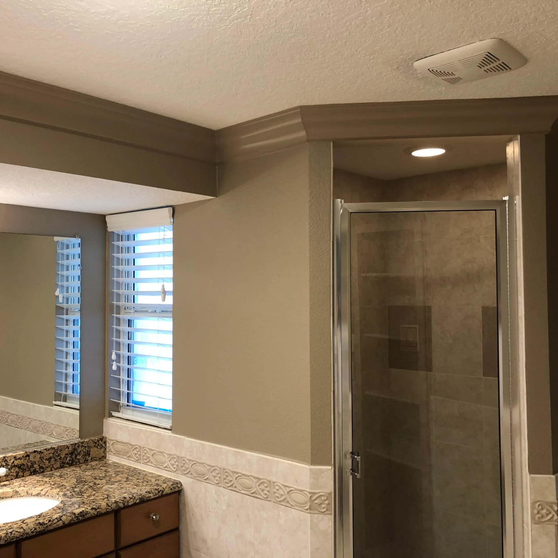 Guest bathroom painted a monochromatic brown tone to complement counter top.